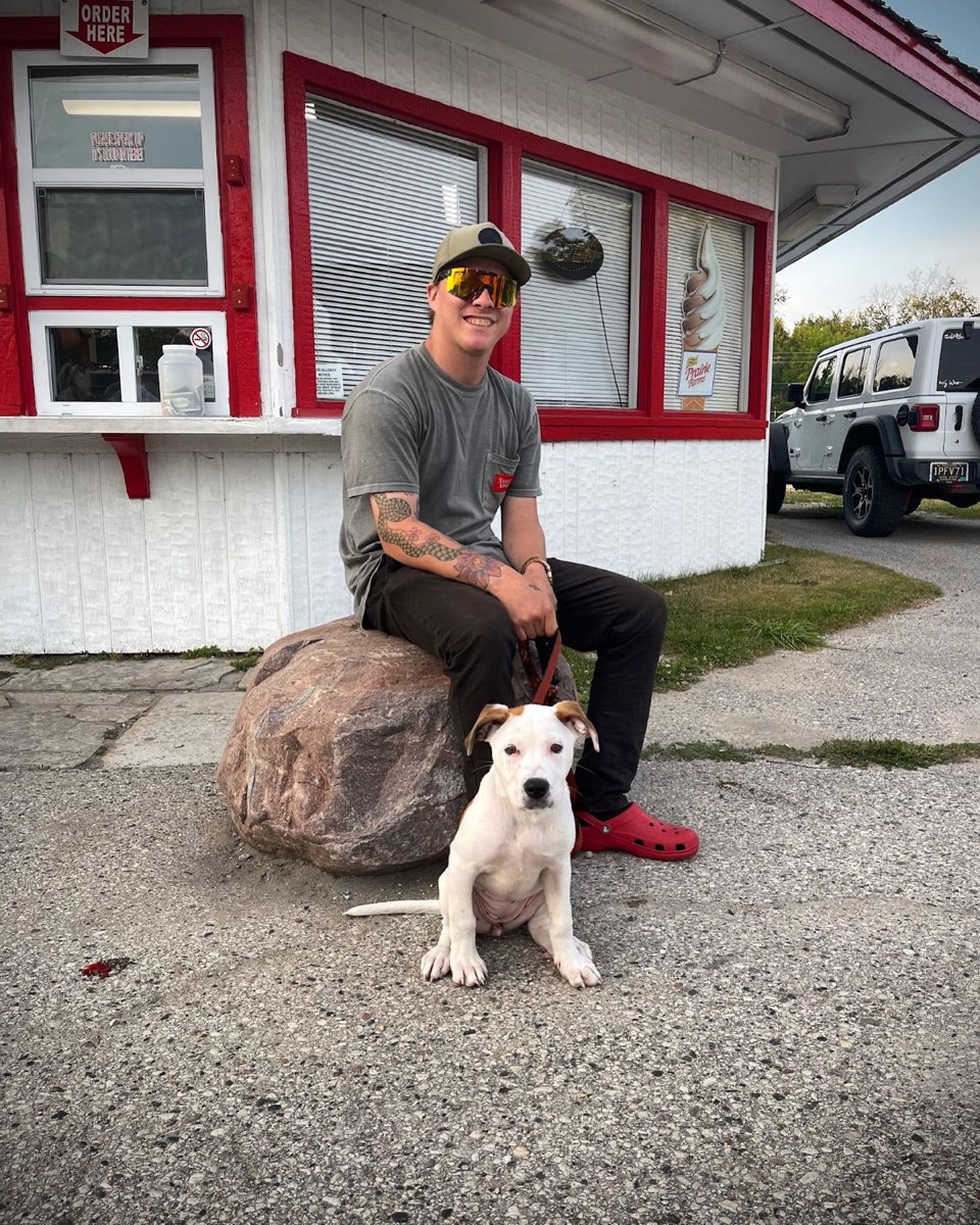 Dameon Spencer with his puppy outside an ice cream stand